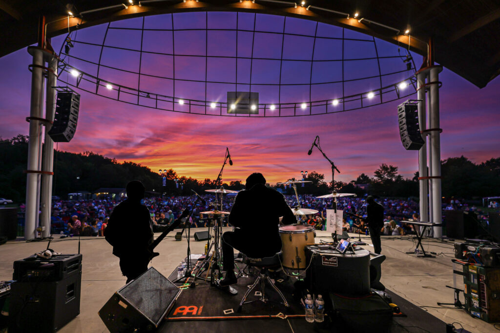 shot from behind drum riser on amphitheater stage